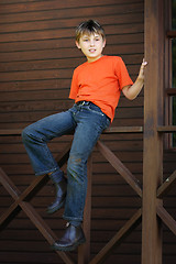 Image showing Boy sitting on the verandah