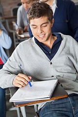 Image showing Student Looking At Exam Paper In Classroom