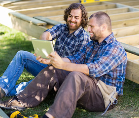 Image showing Happy Carpenters Using Digital Tablet At Construction Site