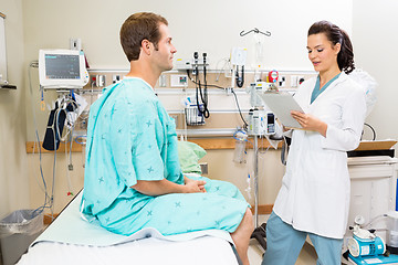 Image showing Doctor With Clipboard Discussing Report With Patient