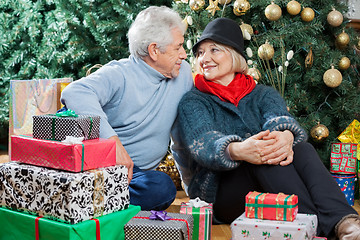 Image showing Couple Sitting With Presents In Christmas Store