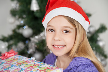 Image showing Girl Wearing Santa Hat With Christmas Gift