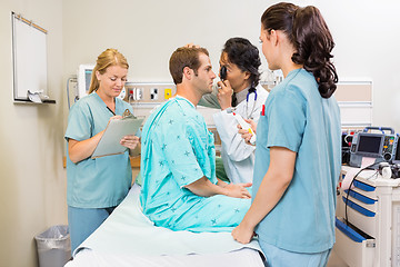 Image showing Medical Team Examining Patient In Hospital