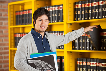 Image showing Student Choosing Book From Shelf In Library