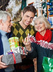 Image showing Man With Parents Shopping In Christmas Store