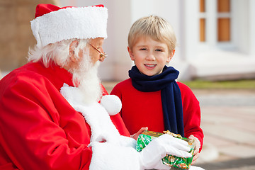 Image showing Boy Taking Present From Santa Claus