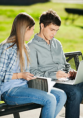 Image showing Friends With Laptop And Book Sitting In Campus