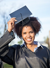 Image showing Woman In Graduation Gown Wearing Mortar Board On Campus