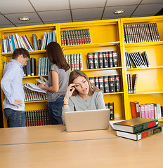 Image showing Confused Student Looking At Laptop In University Library