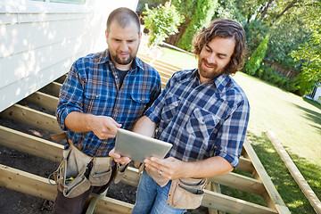 Image showing Workers Discussing Project On Digital Tablet At Construction Sit