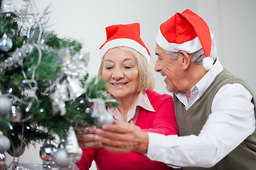 Image showing Senior Couple Decorating Christmas Tree