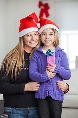 Image showing Mother With Daughter Holding Christmas Present