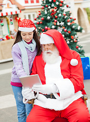 Image showing Santa Claus And Girl Using Digital Tablet