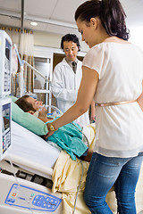 Image showing Woman And Doctor Looking At Critical Patient