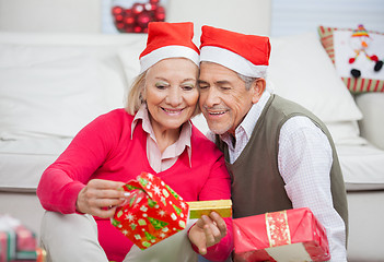 Image showing Loving Couple Looking At Christmas Gifts