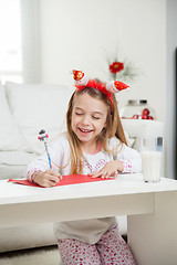 Image showing Happy Girl Writing Letter To Santa Claus