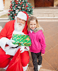 Image showing Girl And Santa Claus Holding Gift