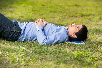 Image showing Student Relaxing On Grass At University Campus