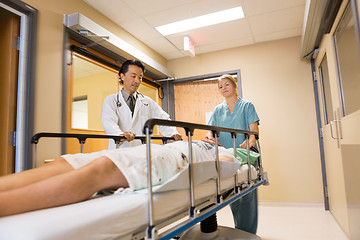 Image showing Doctor And Nurse Taking Patient On Stretcher