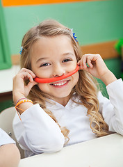 Image showing Girl Holding Mustache Made Of Clay In Preschool