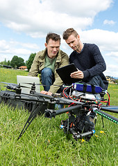 Image showing Technicians Discussing Over Digital Tablet By UAV