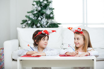 Image showing Siblings Writing Letter To Santa Claus During Christmas