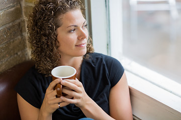Image showing Thoughtful Woman With Coffee Mug In Cafe