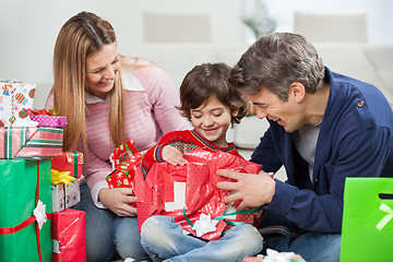 Image showing Boy And Parents Opening Christmas Present