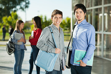 Image showing Male Students With Friends Standing In Background On Campus