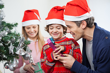 Image showing Father And Son Opening Christmas Gift