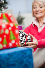 Image showing Senior Woman Holding Christmas Present