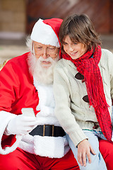 Image showing Santa Claus And Boy Using Smartphone