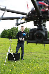 Image showing Engineer Operating  UAV Octocopter in Park