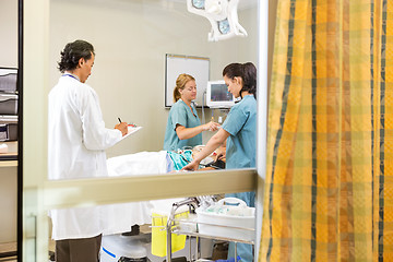 Image showing Nurses And Doctor Examining In Patient