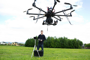 Image showing Male Technician Flying UAV Octocopter