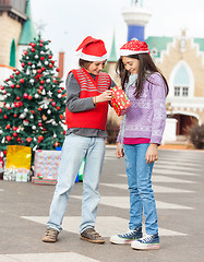 Image showing Friends Opening Christmas Present