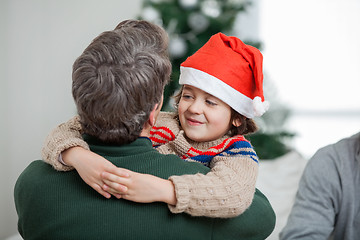 Image showing Son Embracing Father During Christmas