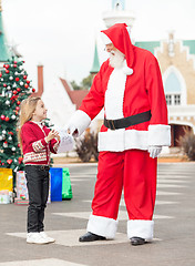 Image showing Girl Giving Wish List To Santa Claus