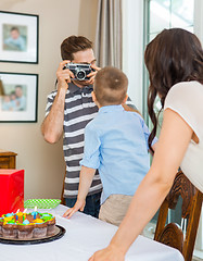 Image showing Father Taking Picture Of Birthday Boy And Woman