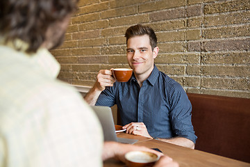 Image showing Smiling Man Having Coffee At Coffee Shop