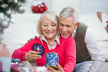 Image showing Happy Senior Couple Looking At Christmas Gift