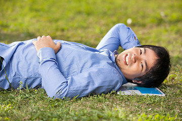 Image showing Male Student Lying On Grass At College Campus