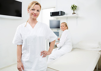 Image showing Confident Gynecologist With Colleague In Background