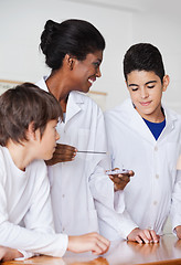 Image showing Teacher Looking At Student While Experimenting At Desk