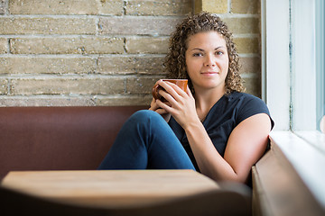 Image showing Woman With Coffee Mug Sitting In Cafeteria