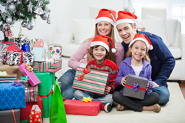 Image showing Family Sitting By Christmas Gifts