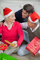 Image showing Son With Parents Holding Christmas Presents