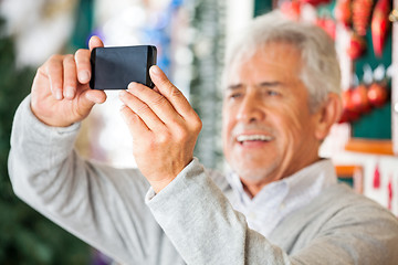 Image showing Man Photographing In Christmas Store