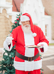 Image showing Santa Claus With Cookies And Milk