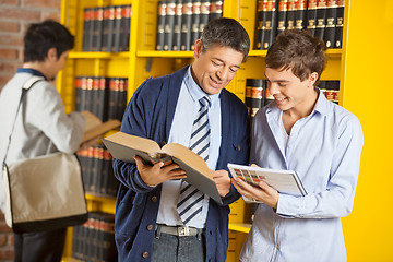 Image showing Librarian Assisting Student In University Library